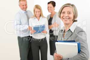 Business team senior woman with happy colleagues