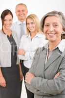 Businesswoman senior with colleagues in the back