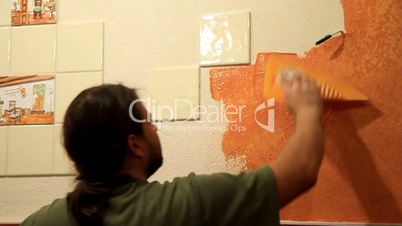 Master applies colored wax on ornamental plaster.