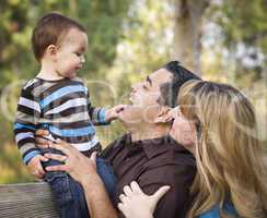 Happy Mixed Race Ethnic Family Playing In The Park