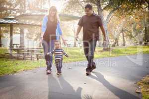 Happy Mixed Race Ethnic Family Walking In The Park