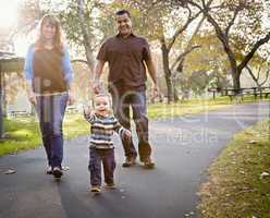 Happy Mixed Race Ethnic Family Walking In The Park