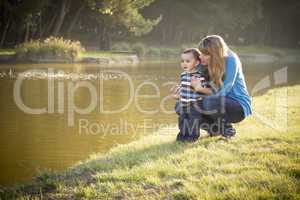 Happy Mother and Baby Son Looking Out At Lake