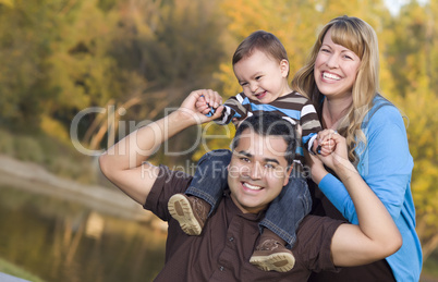 Happy Mixed Race Ethnic Family Posing for A Portrait