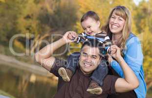 Happy Mixed Race Ethnic Family Posing for A Portrait