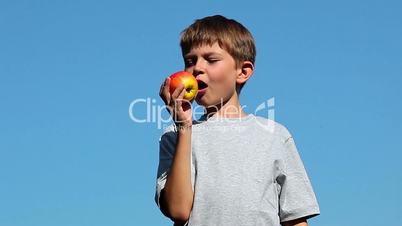 Boy eats apple