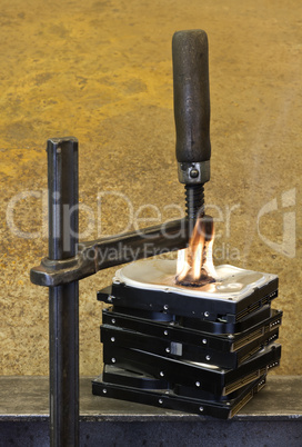 clamp pressing on burning stack of hard drives