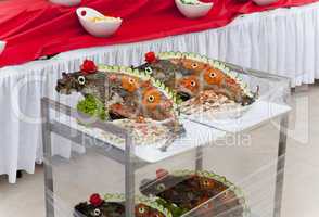 Celebratory food: stuffed fish on served table