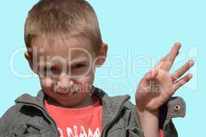little boy showing a gesture