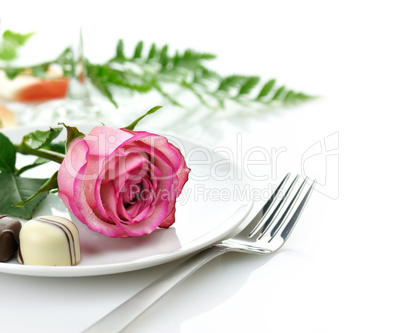 rose and candy on a plate
