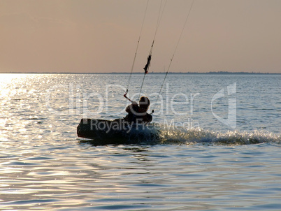 Silhouettes kitesurf on a gulf on a sunset 2