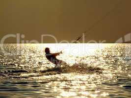 Silhouettes kitesurf on a gulf on a sunseet