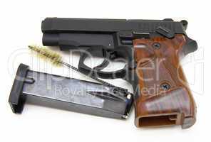 The close up of a pistol a target and cartridges is isolated on