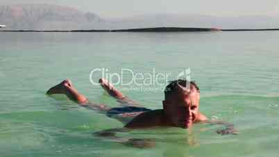 Man floats in the Dead Sea.