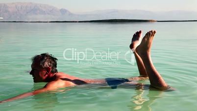 Man floats in the Dead Sea.