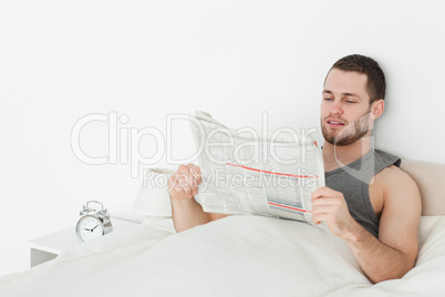 Young man reading a newspaper