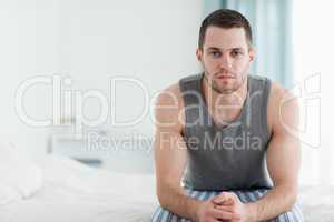 Man sitting on his bed