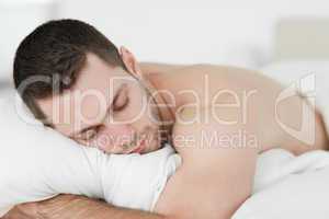Man lying on his belly while sleeping