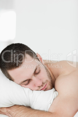 Portrait of a man lying on his belly while sleeping