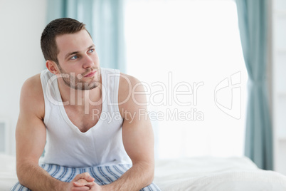 Quiet man sitting on his bed