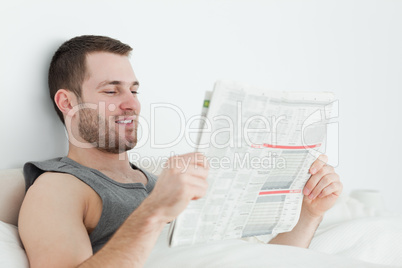 Attractive man reading a newspaper