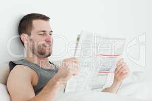 Attractive man reading a newspaper