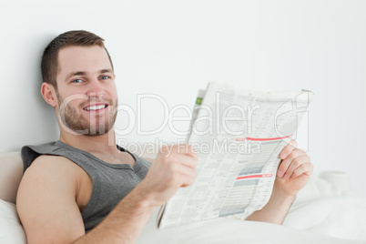 Handsome man reading a newspaper