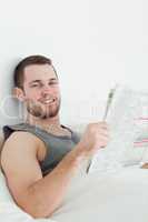 Portrait of a handsome man reading a newspaper