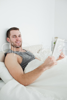 Portrait of a smiling man reading a newspaper