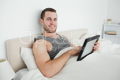 Smiling man using a tablet computer