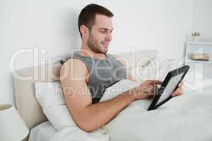 Happy man using a tablet computer