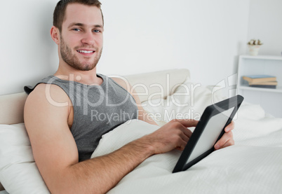 Attractive man using a tablet computer