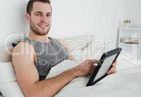 Attractive man using a tablet computer