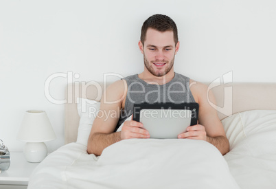 Handsome man using a tablet computer