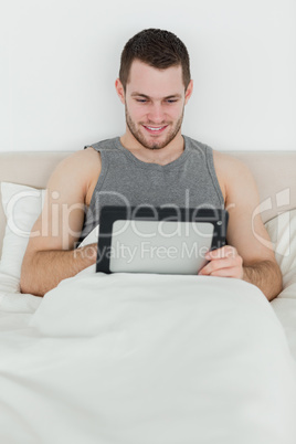 Portrait of a smiling man using a tablet computer