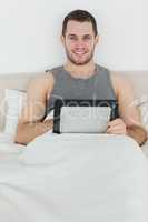 Portrait of a happy man using a tablet computer