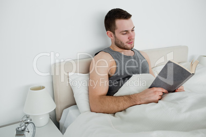 Young man reading a novel