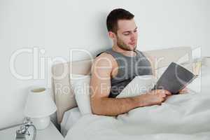 Young man reading a novel