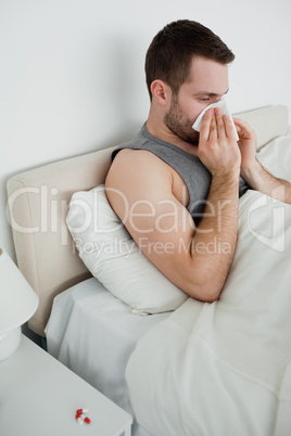 Portrait of a man blowing his nose