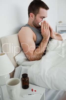 Portrait of a sick man blowing his nose