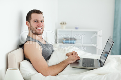 Happy man using a laptop