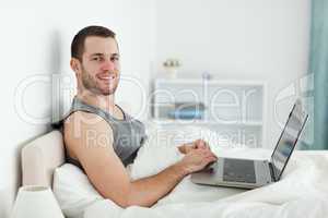 Happy man using a laptop
