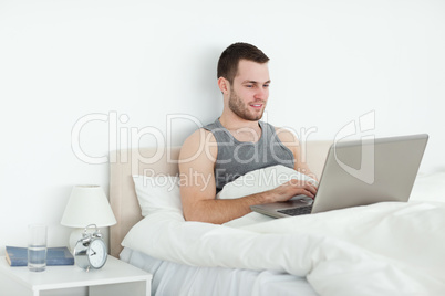 Calm man using a laptop