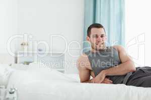 Man posing on his bed