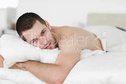 Attractive man lying on his belly