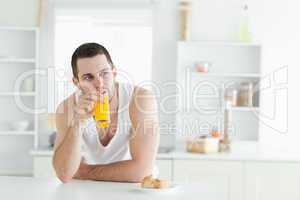 Young man drinking orange juice