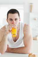 Portrait of a man drinking orange juice