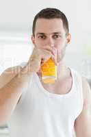 Portrait of a serene man drinking orange juice