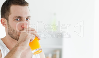 Portrait of a happy man drinking orange juice