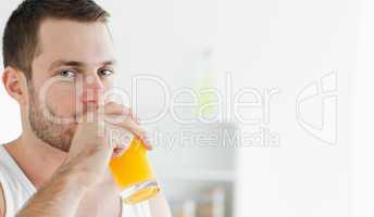 Portrait of a happy man drinking orange juice